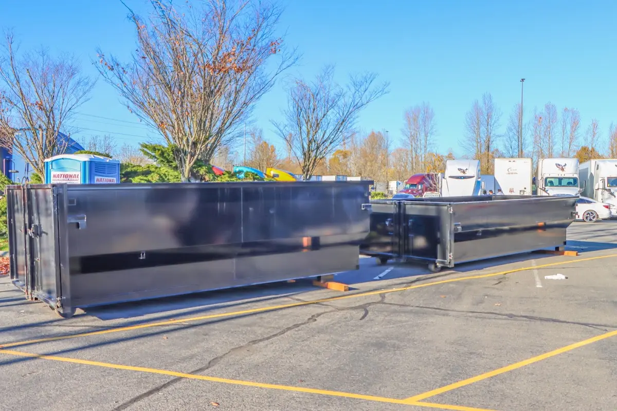 Professional dumpster rental service with roll-off container on residential driveway in Prairie Ridge